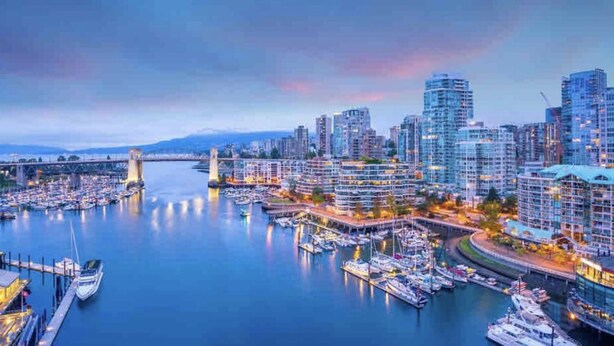 A marina with boats docked, a bridge in the background, and modern high-rise buildings. - Downtown High-rise Condo Amazing View+Pool+Hot Jacuzzi+Sauna+Gym+ free Parking (Vancouver)