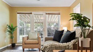 A living room with a sofa, armchair, and a coffee table.