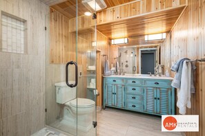 Bathtub, hair dryer, towels, shampoo