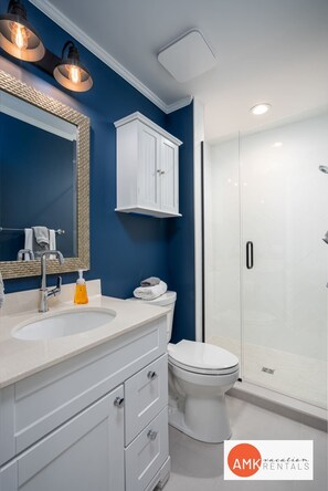 Bathtub, hair dryer, towels, shampoo