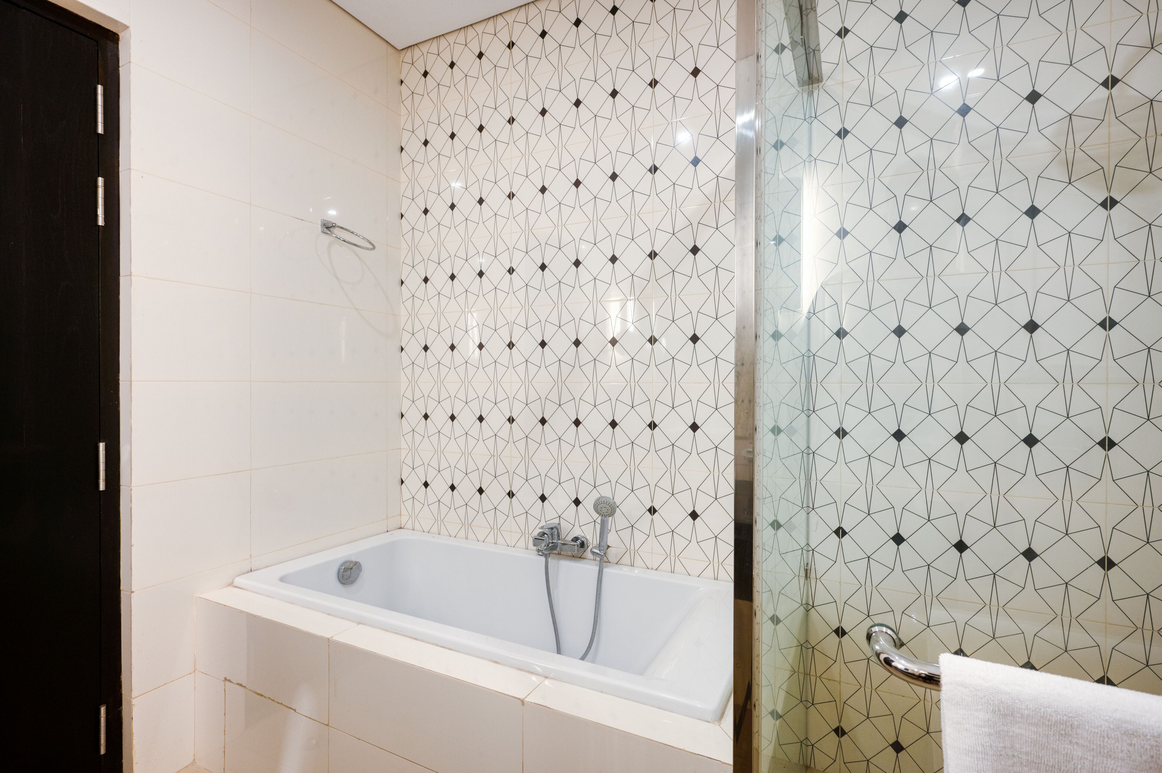 A bathroom with a bathtub, a shower, and a glass-enclosed shower area.