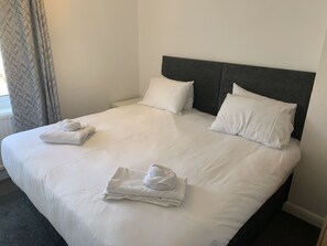 Restful retreat with a neatly made bed and plush linens.