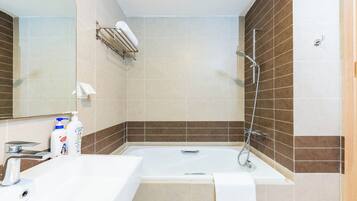 Une salle de bain moderne équipée d’une baignoire, d’un lavabo et d’une douche.