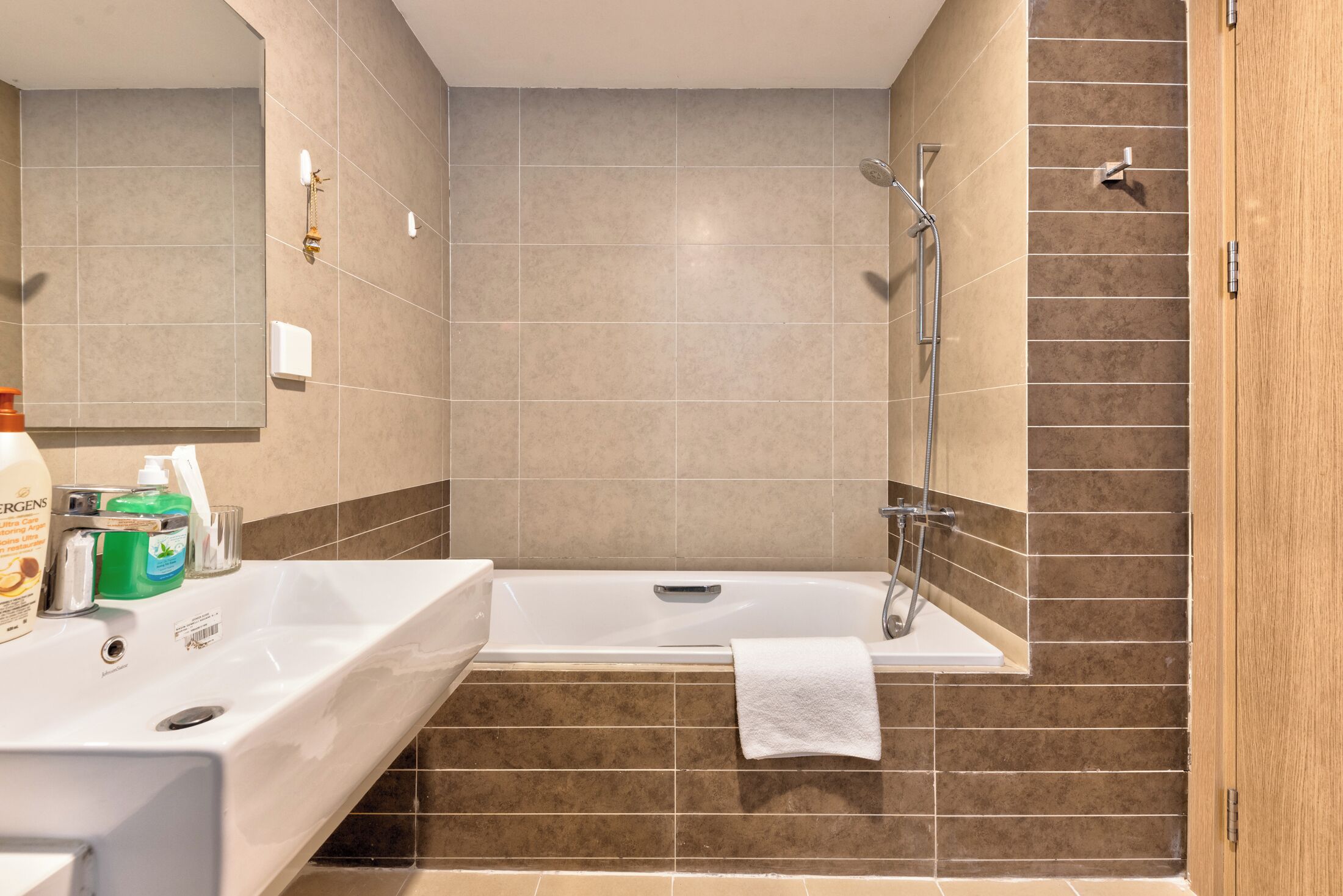 Ein modernes Badezimmer mit einer weißen Badewanne, einem Waschbecken und einer Duschkabine.