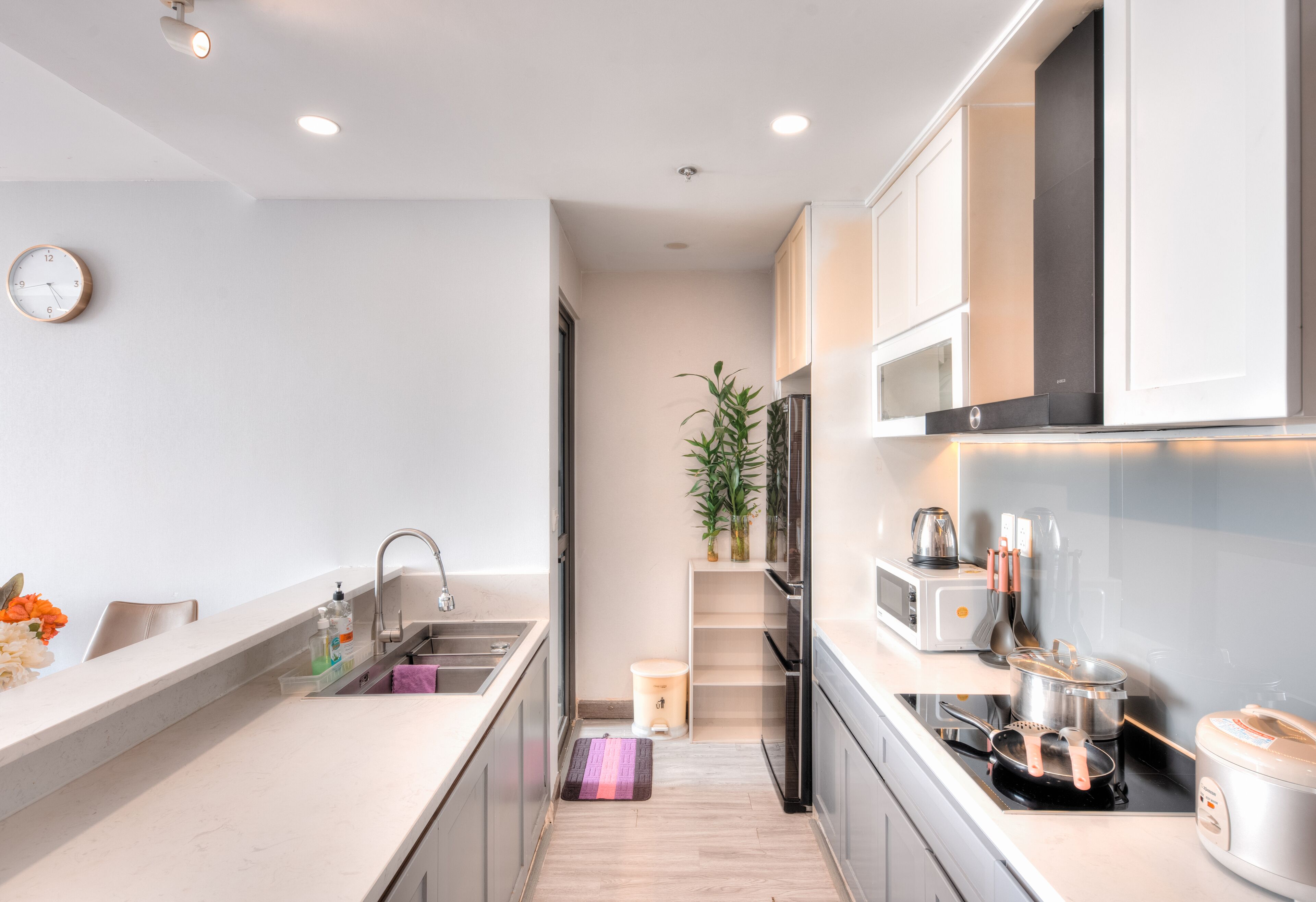 A modern kitchen with a sink, countertop, and appliances.