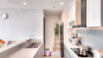 A modern kitchen with a sink, countertop, and appliances.