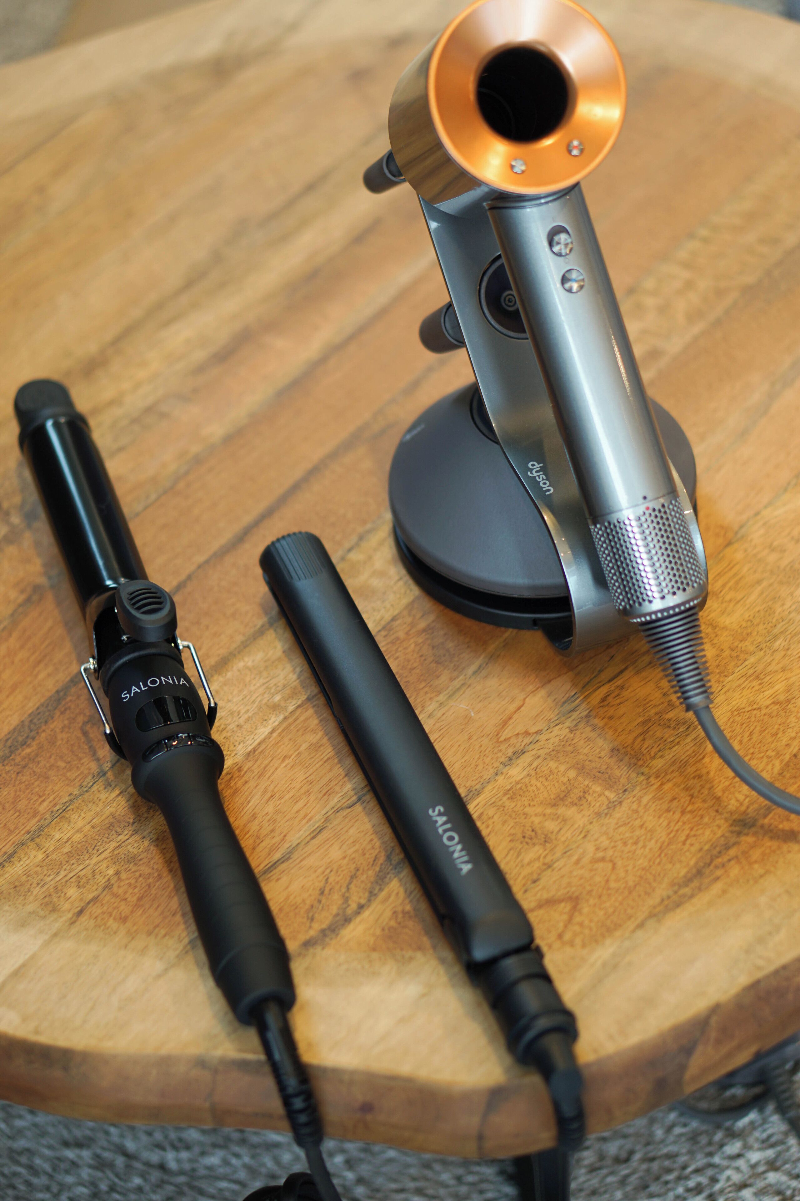 A microphone and headphones on a wooden surface.