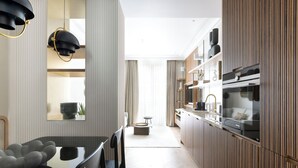 Una cucina moderna con isola centrale, pannelli in legno ed elettrodomestici integrati.