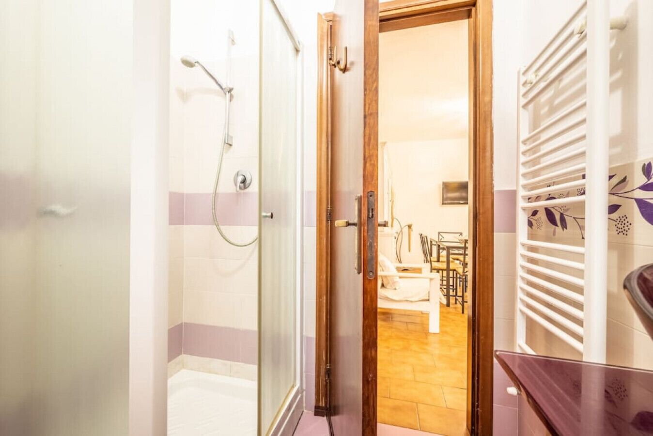 A bathroom with a shower, a toilet, and a sink.