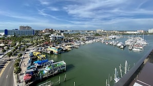 A marina with boats docked, a hotel, and a cityscape in the background. - Paradise on the Wheels Clearwater Beaches (Largo)