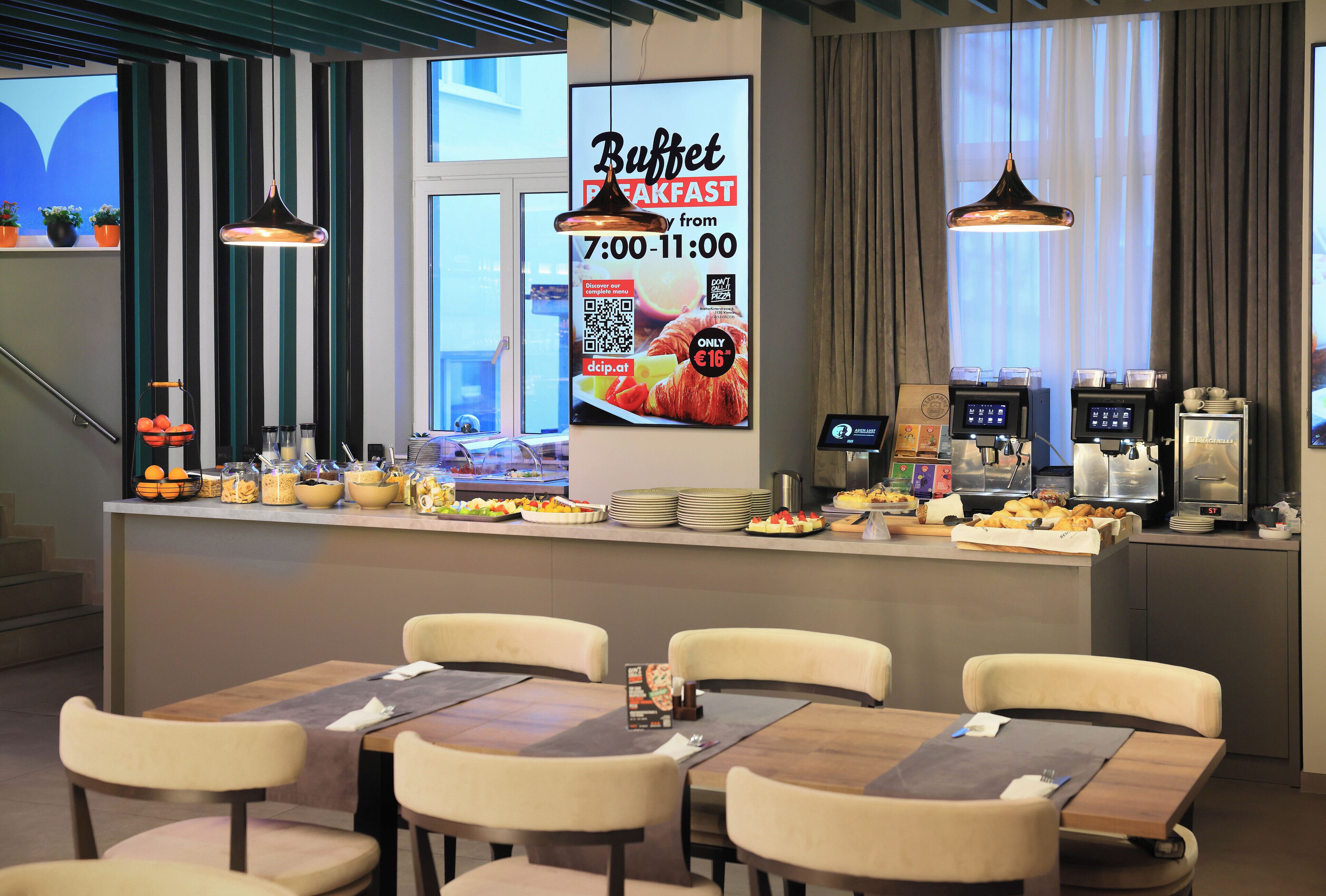 A buffet area with a menu board, self-service beverage station, and seating arrangement.