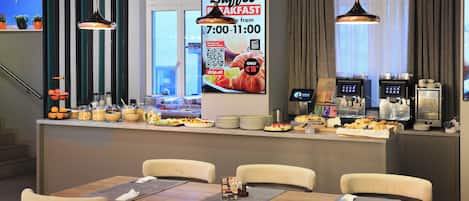A buffet area with a menu board, self-service beverage station, and seating arrangement.
