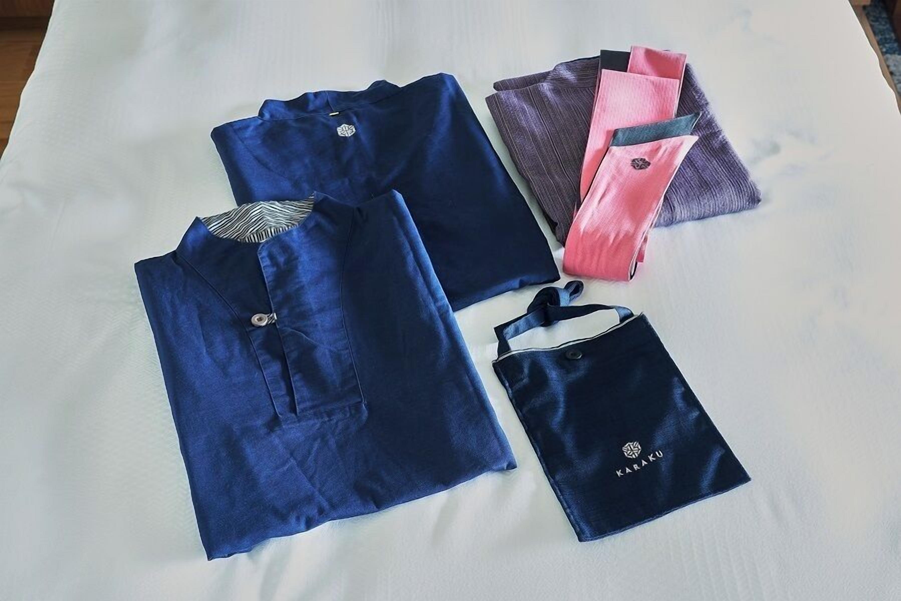 A neatly arranged set of clothing items on a bed.