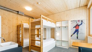 A bunk bed room with a sink and a poster on the wall. - Nordic Hostel (Lantsch-Lenz)