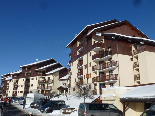 Experience the charm of this traditional alpine hotel, offering stunning views from its balconies with railings.