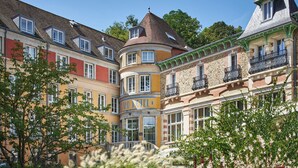 A historic building with a central courtyard, multiple balconies, and a variety of architectural styles.