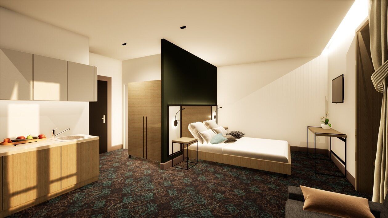 A modern hotel room with a bed, a small desk, a vanity with a mirror, and a kitchenette.