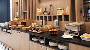 Disposição de buffet com diversos alimentos e utensílios de cozinha.