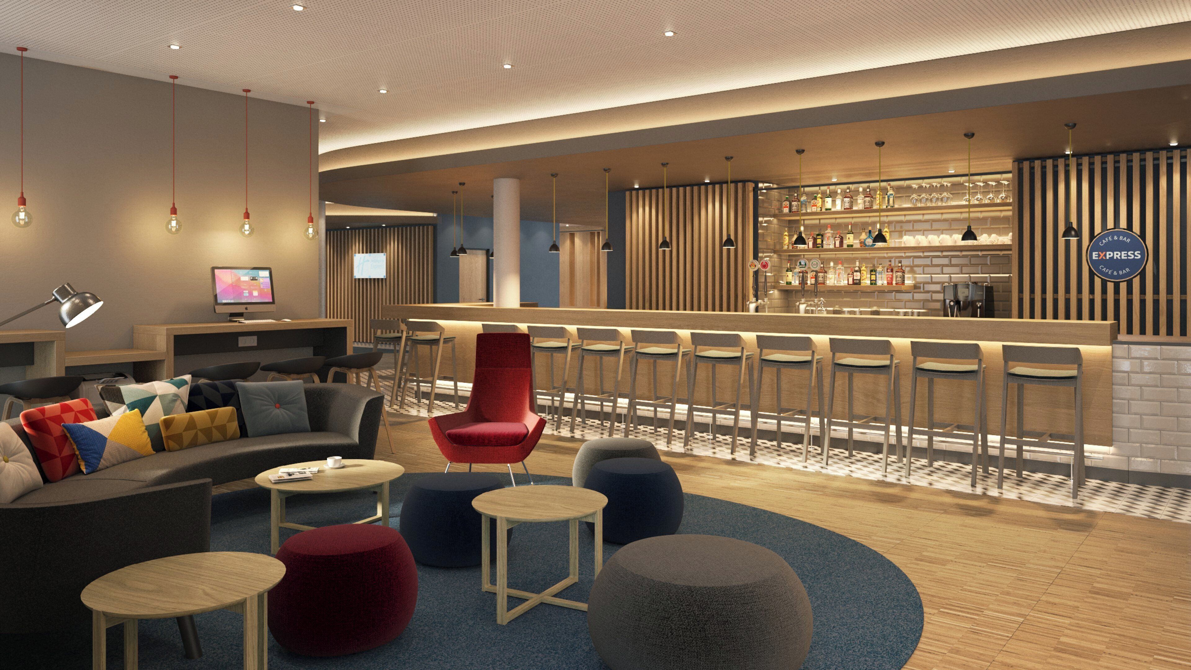 A modern lounge area with a bar, seating arrangements, and a television screen.