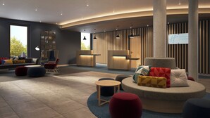 A modern lobby with a reception desk, seating areas, and a large window providing a view of the outdoors. - Holiday Inn Express Bochum by IHG (Bochum)