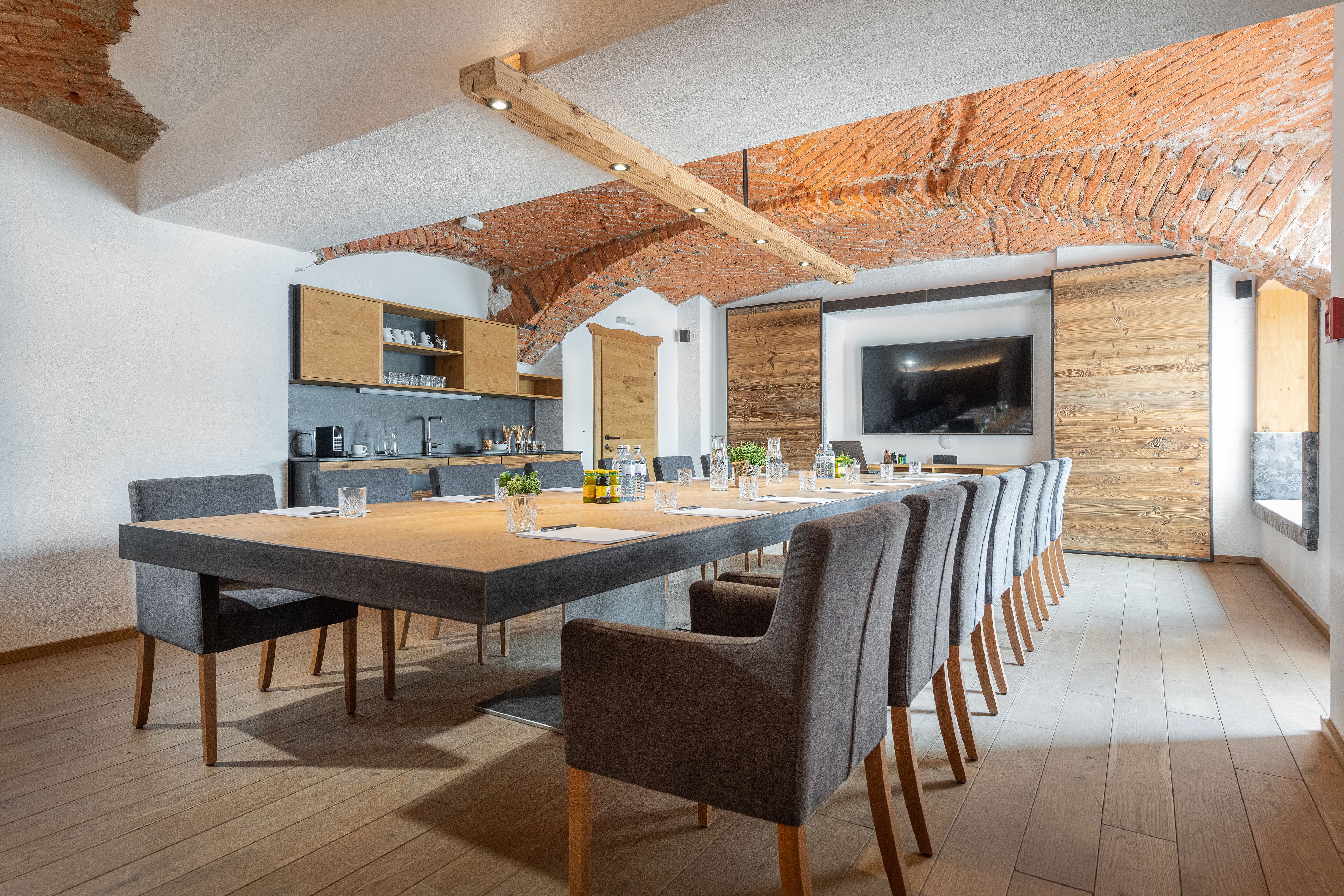 A modern kitchen with wooden cabinets, a large island, and a built-in oven.