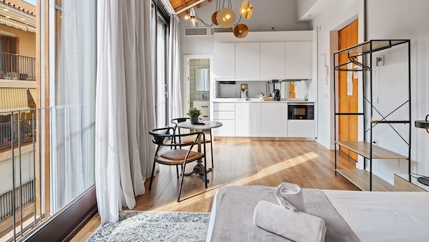 Eine moderne Wohnung mit Essbereich, Küche und einem Balkon mit Blick.
