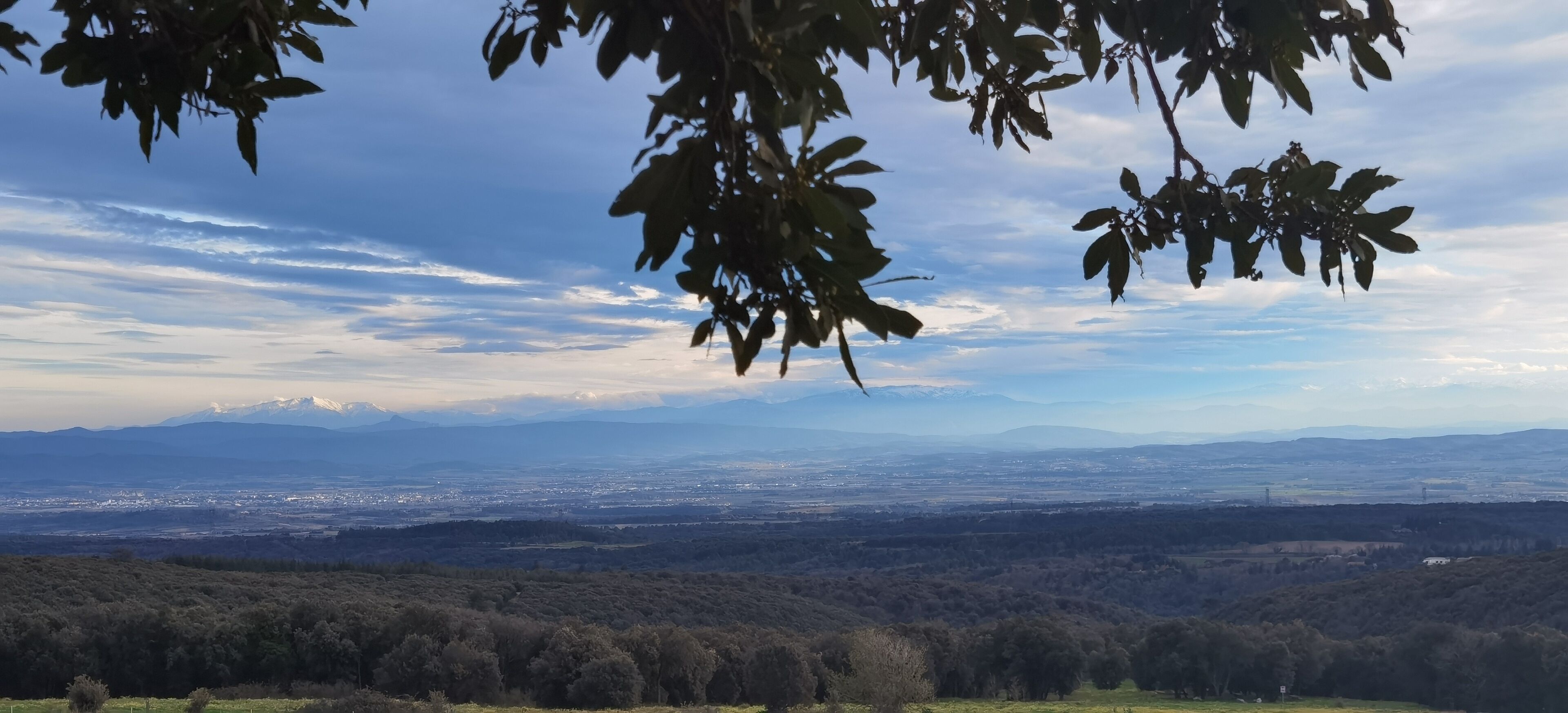 A panoramic view of a mountainous landscape with a valley below.