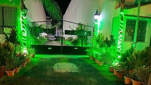 A gated entrance with a sign reading "CAMPING". - TM Inn (Kanchipuram)