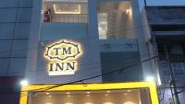 A building with a sign reading "TM INN" indicating a hotel.