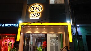 A multi-story building with a prominent TM INN sign at the entrance. - TM Inn (Kanchipuram)