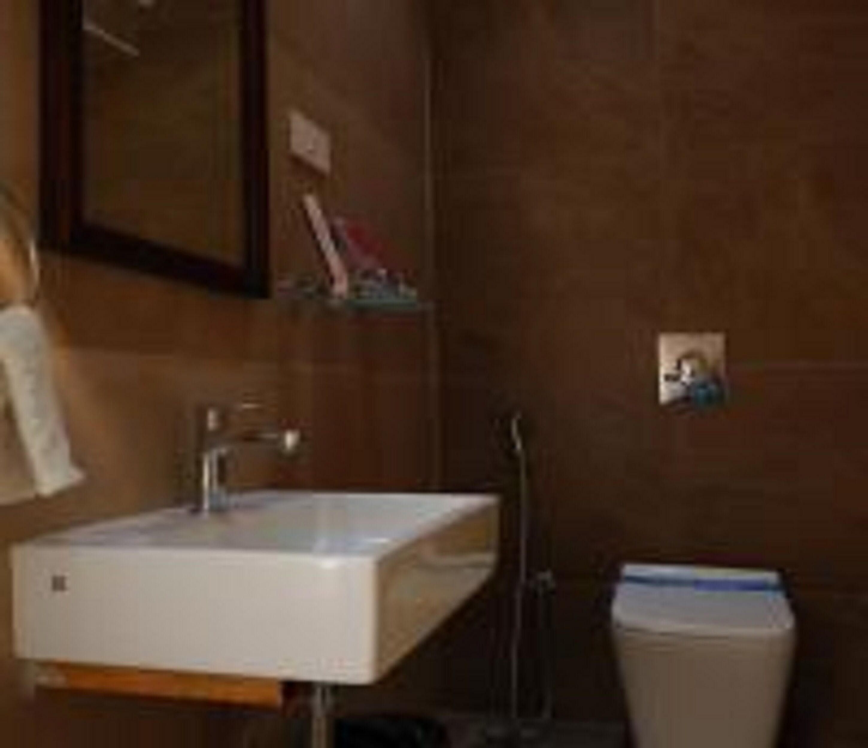 A bathroom with a white sink, a mirror, and a shower.