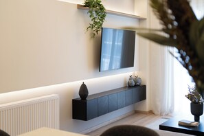 City Apartment | Living area | 55-inch Smart TV with cable channels