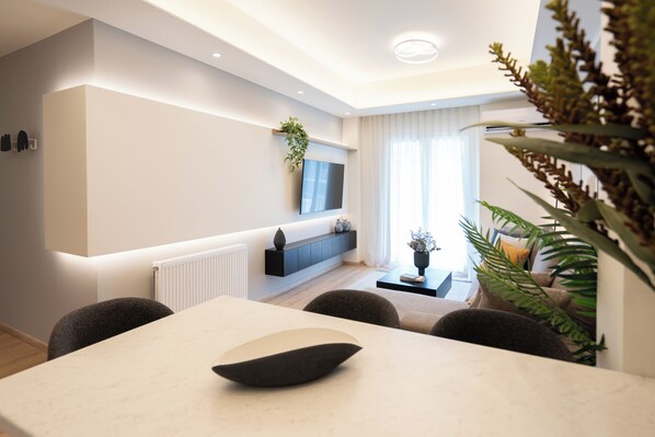 City Apartment | Living area | 55-inch Smart TV with cable channels