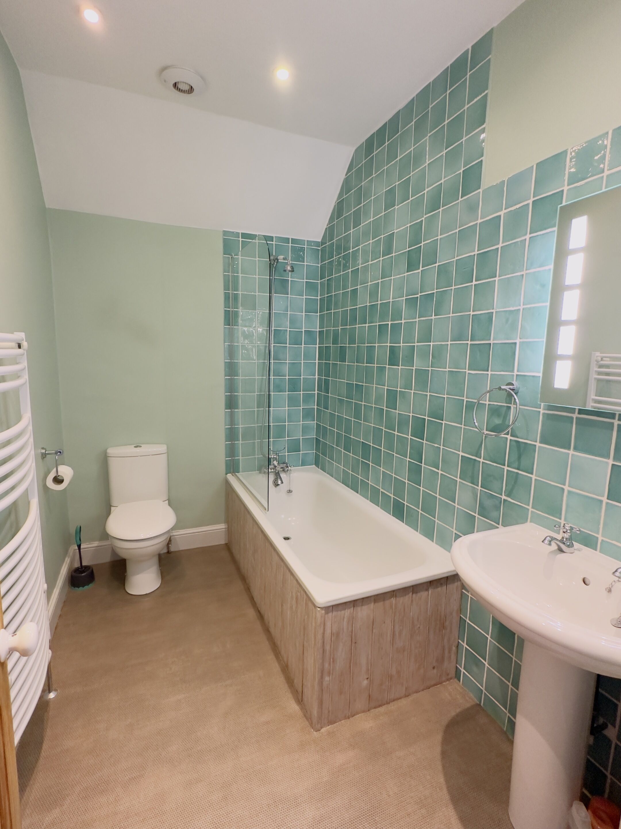 A bathroom with a bathtub, toilet, and sink.