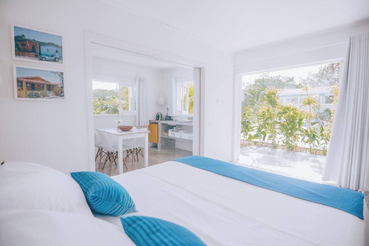 Una habitación de hotel con cama, escritorio y vista al exterior.