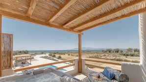 A hot tub with a view of the beach and mountains.