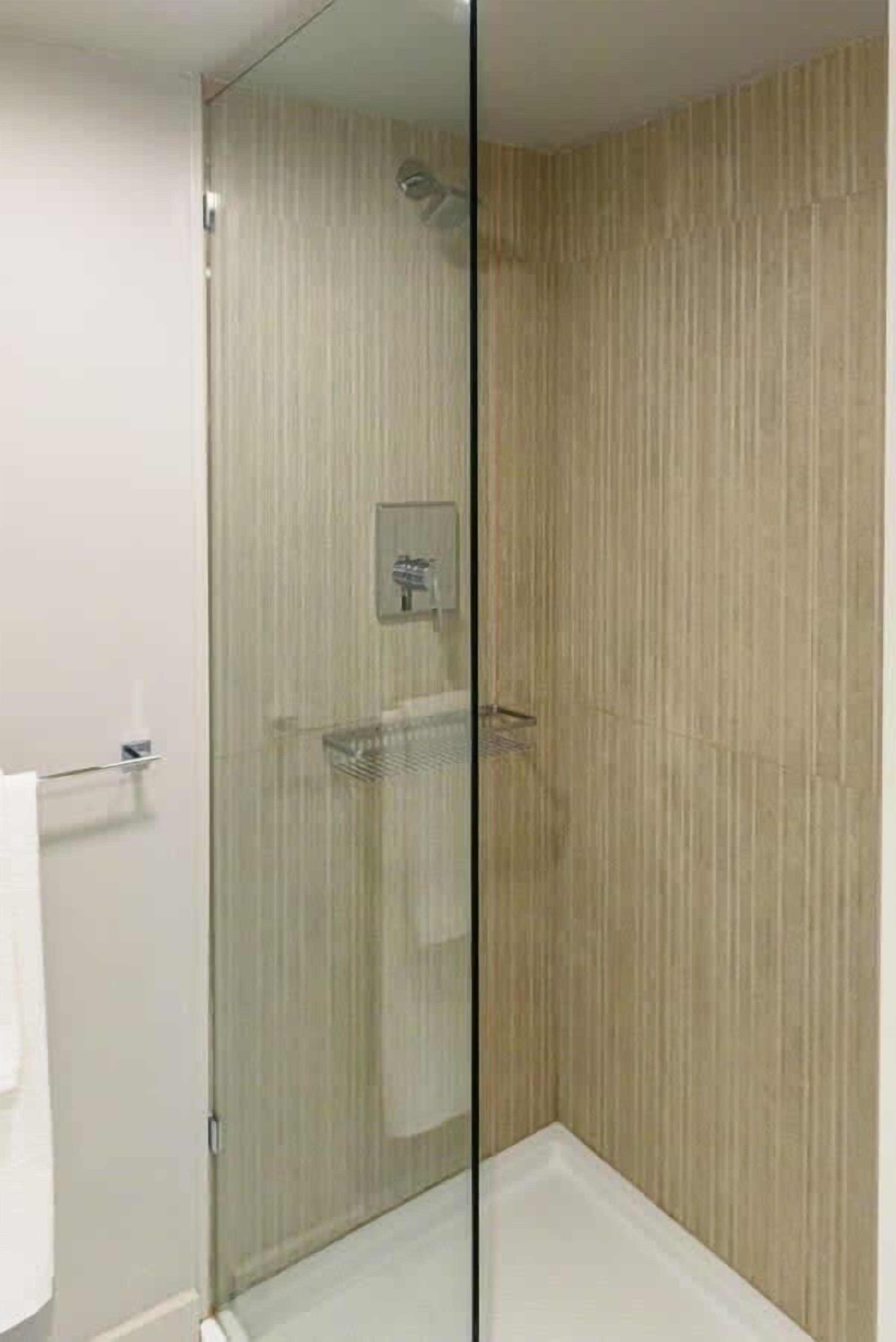 Bathtub, hair dryer, towels, shampoo