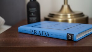 A book titled 'Little Book of Prada' on a wooden surface. - Spacious Apartment, Near to NEC and City Centre.  (Solihull)