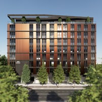 A modern hotel building with multiple floors, large windows, and a flat roof.