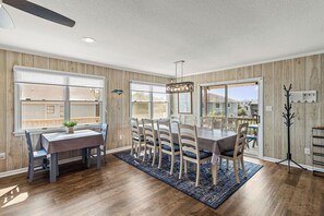 Enjoy meals in this dining area with a view, featuring a dining table and chairs.