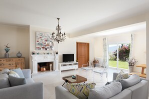 Panoramic Villa | Living area | 50-inch Smart TV with cable channels, TV, fireplace - Villa Fantasia Isthmia (Corinth)