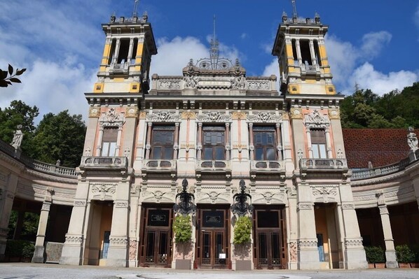 Un edificio histórico con arquitectura ornamentada, que presenta dos torres y una cúpula central.