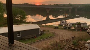 A riverside view with a bridge, a trailer, and a small building. - Double Queen Room (Warsaw)