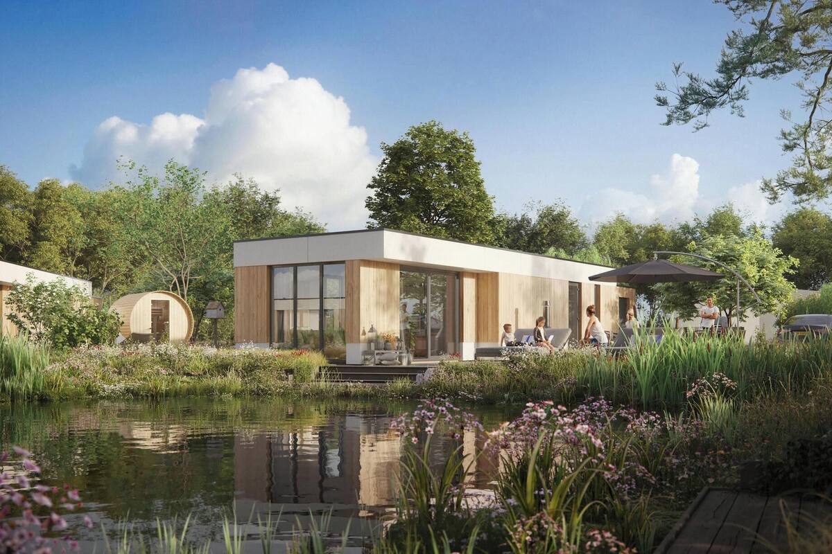 A modern building with large windows, a pond, and surrounding greenery.