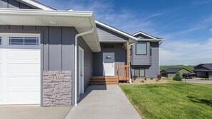 A residential house with a garage, a stone accent wall, and a number '5360' plaque.