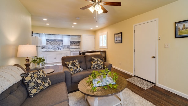 A living room with a sofa, coffee table, and a ceiling fan. - Sunny California Retreat w/ Pool Access & Patio! (Shasta Lake)