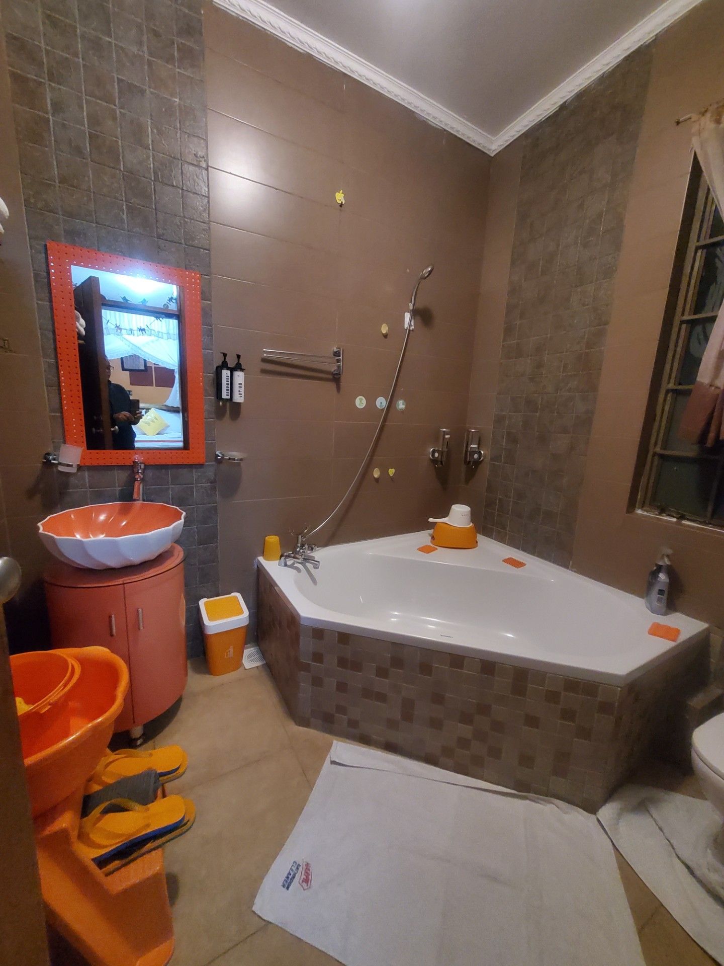 A bathroom with a large bathtub, a sink, and a mirror.