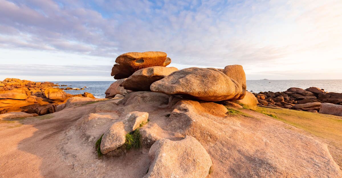 A rocky landscape with large boulders and a clear sky.