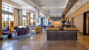 A spacious lobby with a reception desk, seating areas, and large windows. - Hyatt Place Nashville Green Hills (Nashville)