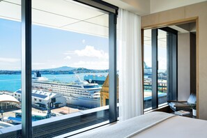 A hotel room with a large window offering a view of a cruise ship docked at a port. - Intercontinental Auckland (Auckland)